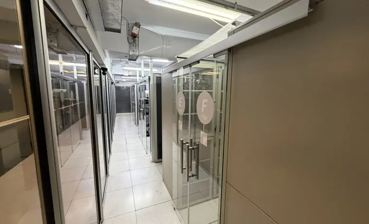 Acceso a las filas E y F de la sala de datos, con cerramientos de malla y vidrio